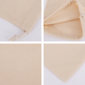 Macro view of beige cotton canvas drawstring pouch showing fabric texture and drawstring