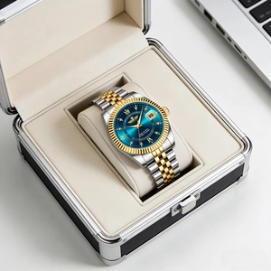 Detail of blue sunray dial watch with gold fluted bezel in premium gift box packaging