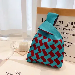 Knitted tote bag with blue and red checkerboard pattern in a casual triangular design