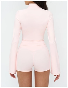 Detail view of pink yoga jacket back seam and high waist shorts with flare sleeve detail