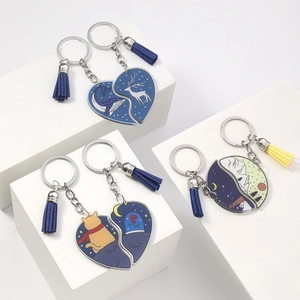 Detail of creative acrylic puzzle keychains with heart and sun-moon motifs and tassels