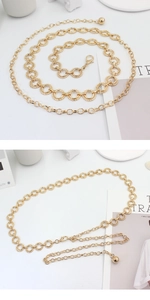 Detail of adjustable gold ring chain belt with lobster clasp and sleek metal texture
