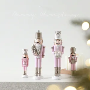 Pink and silver nutcracker figures set with Christmas tree and drum for holiday decor