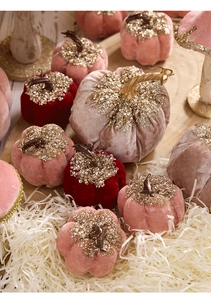 Detail of velvet pumpkins with gold sequins and artistic stems for autumn decor