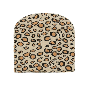 Close-up of leopard print knitted beanie showing detailed khaki and brown jacquard texture
