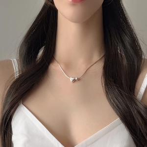 Minimalist 925 sterling silver heart bead necklace on a model for a chic, aesthetic look