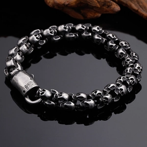 Retro stainless steel skull bracelet for men featuring an oxidized silver finish and industrial clasp