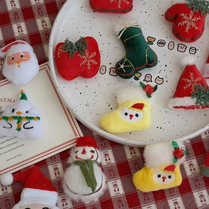 Detailed view of assorted Christmas plush charms with embroidery for DIY holiday bouquets