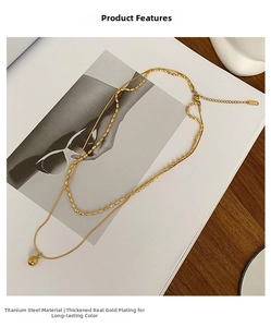 Detail of 18K gold plated titanium steel double layer necklace with polished metal beads