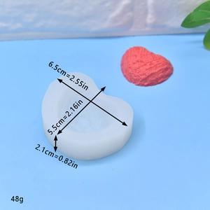 Heart-shaped silicone mold for DIY soap and candles with dimension labels and red heart sample