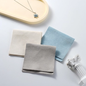 Three premium microfiber jewelry pouches in beige, gray, and blue for necklace storage