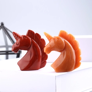 Hand-carved crystal unicorn head figurines in red jasper and orange agate stones