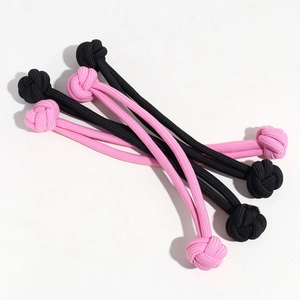 Detailed view of four durable braided rope knots in black and pink for pet chewing