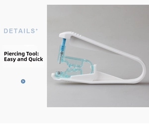 Macro detail of a sterile disposable ear piercing gun with white plastic frame and needle