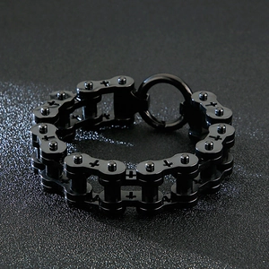 Close-up of black stainless steel motorcycle chain bracelet with cross pattern detail