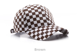 Detail view of the brown and white checkerboard baseball cap with adjustable buckle strap