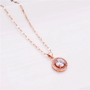 Close-up of rose gold necklace with round cubic zirconia pendant on flat link chain