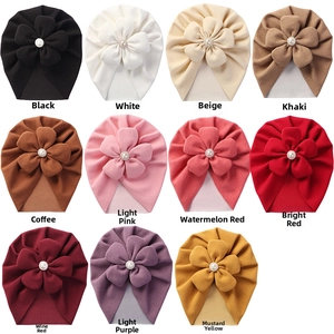 Detailed grid of soft cashmere-like baby hats with large floral pearls in 11 colors