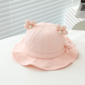 Detail of pink baby sun hat with textured fabric, 3D floral accents and a cute side bow