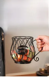 Detail of black metal coffee pod basket with cup shape, handle and COFFEE label