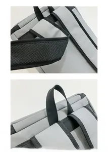 Close-up of the grey travel backpack showing reinforced top handle and breathable mesh straps