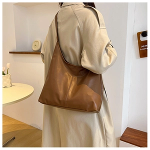 Brown large capacity shoulder bag shown on model for professional everyday commuter style