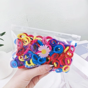 Detail of colorful elastic hair bands in a transparent daisy print storage bag