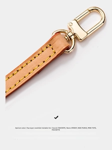 Detail of apricot genuine cowhide leather shoulder strap with gold metal spring buckle