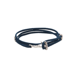 Detail of dark blue braided Milan rope bracelet with silver anchor clasp on white background
