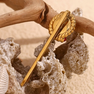 Detail of vintage 18K gold plated stainless steel hair clip with red gemstone and pearl