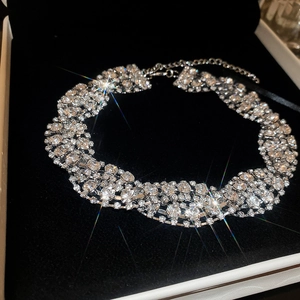 Macro shot of silver twisted choker necklace with crystals in a velvet jewelry box