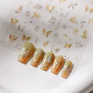 Macro view of 5D embossed butterfly nail stickers with gold foil and pearl accents
