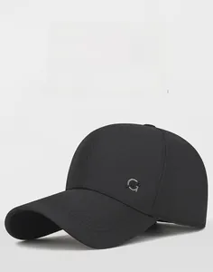 Close-up of a black baseball cap featuring a premium metal G-letter side ornament