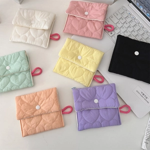 Detailed view of colorful heart-quilted sanitary storage pouches with snap closure