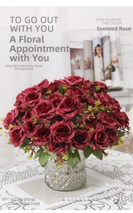Detailed close-up of dark red artificial roses in a textured glass vase on lace fabric