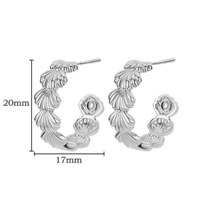 Close-up of silver C-shaped hoop earrings with seashell texture measuring 20mm by 17mm