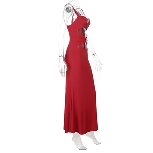Close-up of side cut-out details on a red floor-length dress with rhinestone buckles