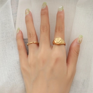 Golden angel relief signet ring and hollow chain ring set on model hand
