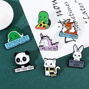 Detailed collection of colorful enamel animal pins with fun slogans on green background