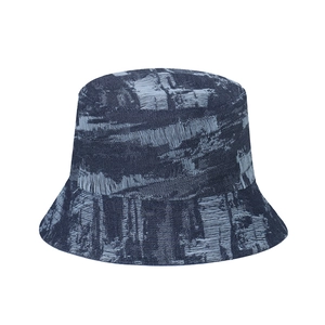 Unisex distressed denim bucket hat featuring frayed edges and vintage washed finish