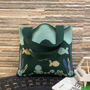 Detailed knit texture of green ocean themed tote bag with octopus and fish patterns