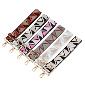 Adjustable wide canvas shoulder straps with geometric patterns and gold metal buckles
