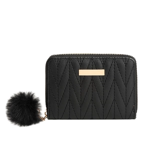 Black quilted zip-around wallet with golden metal plate and fluffy pompom keychain