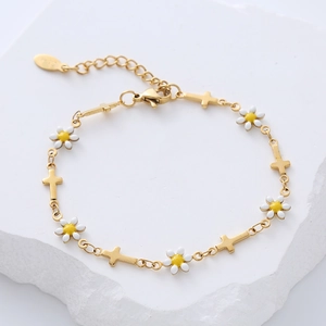 Detail of 18k gold plated bracelet with white enamel daisies and gold cross charms