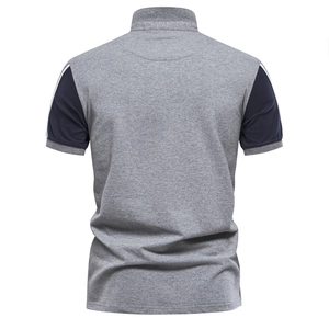 Detail view of the back of a men's gray polo shirt with navy blue tipped sleeves