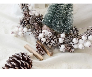 Close-up of pine cones and white berries on a vintage Christmas wreath with a snow-like texture