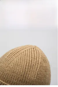 Detail of khaki ribbed knit beanie showing thick texture and windproof embroidery