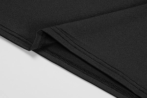 Macro detail of the double-needle flat seam on the black knitted dress asymmetric hem