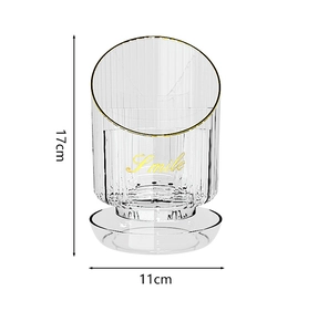 Detail view of transparent rotating makeup brush holder with gold trim and Smile text