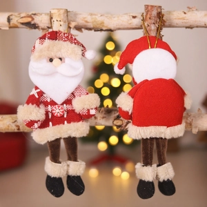 Classic plush Santa Claus hanging ornament with red plaid details on a wooden branch